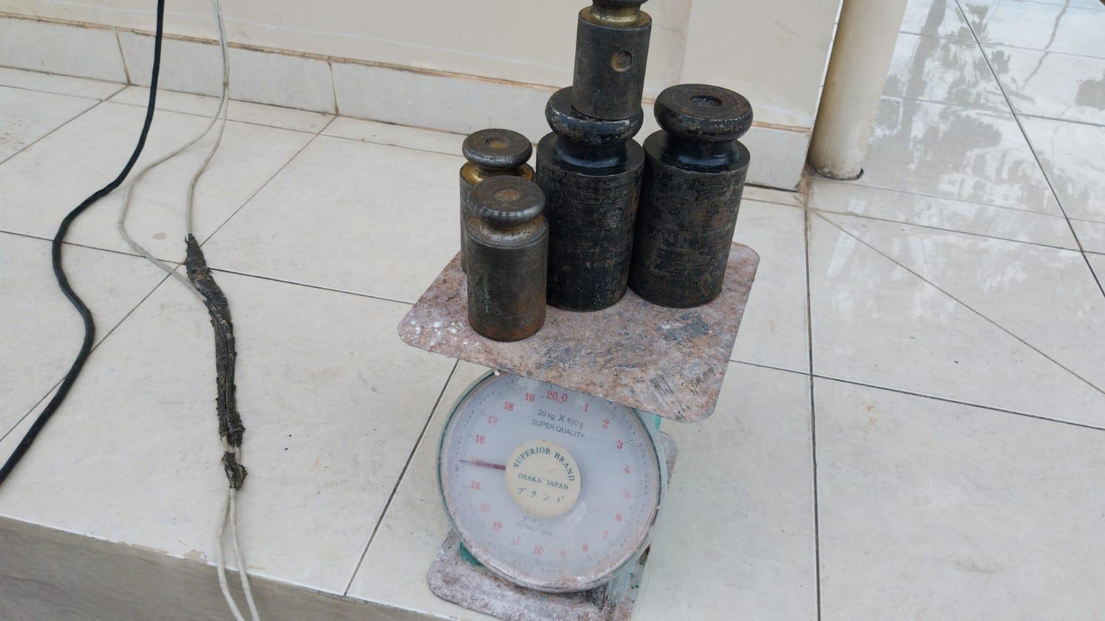 Standard weights on a mechanical dial scale used for verification testing